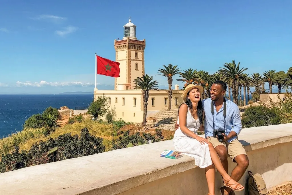 Private tours in Tangier - Cape Spartel lighthouse with tourists enjoying panoramic views of the Atlantic Ocean